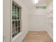 A view of the walk-in closet featuring wood-look flooring and shelving for storage at 7 Dubarry Ct, Durham, NC 27705