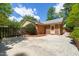 Large concrete driveway with lush trees and landscaping in front of the beautiful brick house at 7 Dubarry Ct, Durham, NC 27705