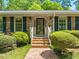 Close-up of the home's front entrance with brick steps and well-kept landscaping at 7 Dubarry Ct, Durham, NC 27705
