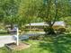 Charming single-story home featuring a well-manicured lawn and lush landscaping, creating a serene curb appeal at 7 Dubarry Ct, Durham, NC 27705