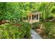 Charming one-story home with lush, mature landscaping around the front entry at 7 Dubarry Ct, Durham, NC 27705