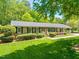 Beautiful brick home with green shutters, neat landscaping, and a lush green lawn at 7 Dubarry Ct, Durham, NC 27705