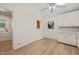 Bright kitchen area with painted cabinets, light countertops, wood flooring, and a view into another room at 7 Dubarry Ct, Durham, NC 27705