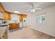 Bright kitchen with wooden cabinets, white appliances, and hardwood floors, creating a warm and inviting space at 7 Dubarry Ct, Durham, NC 27705