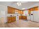 Functional kitchen featuring ample wooden cabinetry, modern white appliances, and easy-to-clean hardwood floors at 7 Dubarry Ct, Durham, NC 27705