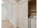 Bright laundry room featuring white cabinets, washer, dryer, and closet for ample storage at 7 Dubarry Ct, Durham, NC 27705