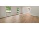 Sunlit living room featuring beautiful hardwood floors and large windows offering serene views at 7 Dubarry Ct, Durham, NC 27705