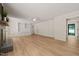 Open living room with wood flooring, white built-ins, light walls, and an open floorplan at 7 Dubarry Ct, Durham, NC 27705