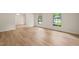 Bright living room with hardwood floors and large windows, providing ample natural light and a spacious feel at 7 Dubarry Ct, Durham, NC 27705