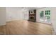 Spacious living room with wood flooring, brick fireplace, and exterior door access to back deck at 7 Dubarry Ct, Durham, NC 27705