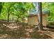 Backyard view of a shed with siding and a dark roof in a wooded yard at 7 Dubarry Ct, Durham, NC 27705