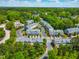 Aerial view of community featuring colorful townhomes surrounded by lush greenery at 705 Samuel Cary Dr, Cary, NC 27511