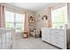 Bright Bedroom with plush carpet, white dresser, and natural light from the window at 705 Samuel Cary Dr, Cary, NC 27511