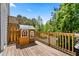 Outdoor deck featuring a charming playhouse with a view of lush greenery and blue sky at 705 Samuel Cary Dr, Cary, NC 27511