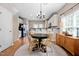 Cozy dining area featuring hardwood floors, modern lighting, and a seamless connection to the kitchen at 705 Samuel Cary Dr, Cary, NC 27511