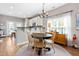 Bright dining area with hardwood floors, stylish lighting, and a seamless connection to the kitchen at 705 Samuel Cary Dr, Cary, NC 27511