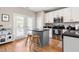 Stylish kitchen with stainless steel appliances, granite countertops, and hardwood floors with outdoor access at 705 Samuel Cary Dr, Cary, NC 27511