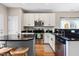 Bright kitchen featuring stainless steel appliances, an island with stools, and ample cabinet space at 705 Samuel Cary Dr, Cary, NC 27511