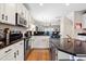 Modern kitchen featuring stainless appliances and a dark countertop island with an open floorplan at 705 Samuel Cary Dr, Cary, NC 27511