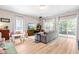 Bright living room with light wood floors, sliding glass doors, comfortable seating, and a large screen TV at 705 Samuel Cary Dr, Cary, NC 27511
