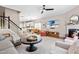 Open-concept living room featuring a fireplace, hardwood floors, and seamless flow to the kitchen at 705 Samuel Cary Dr, Cary, NC 27511