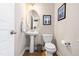 Charming powder room featuring a pedestal sink, oval mirror, and decorative wall art at 705 Samuel Cary Dr, Cary, NC 27511