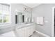 Well-lit bathroom featuring a tub, shower, and double vanity with marble countertops at 7101 Gibson Creek Pl, Cary, NC 27519
