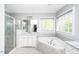 Bathroom featuring a soaking tub, a shower with glass door, and double sinks at 7101 Gibson Creek Pl, Cary, NC 27519
