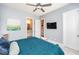 Bedroom with attached bathroom and closet entrances, ceiling fan, and carpet at 7101 Gibson Creek Pl, Cary, NC 27519