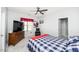 Cozy bedroom with a ceiling fan, dresser, reading chair, and a plaid comforter on the bed at 7101 Gibson Creek Pl, Cary, NC 27519