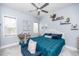 Comfortable bedroom with a plush bed, blue accents, and plenty of natural light at 7101 Gibson Creek Pl, Cary, NC 27519
