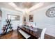 Well-appointed dining room with a stylish chandelier, wainscoting, and ample seating at 7101 Gibson Creek Pl, Cary, NC 27519