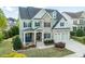 Inviting curb appeal with stone details, an inviting front porch, and a two-car garage at 7101 Gibson Creek Pl, Cary, NC 27519