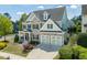 Charming home featuring stone accents, a well-kept lawn, and an attached two-car garage at 7101 Gibson Creek Pl, Cary, NC 27519