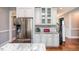 Kitchen with stainless steel refrigerator, granite countertops, and white cabinets at 7101 Gibson Creek Pl, Cary, NC 27519