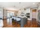 Open kitchen with island, granite countertops, and stainless steel appliances at 7101 Gibson Creek Pl, Cary, NC 27519
