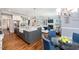 Open-concept kitchen and dining area features granite countertops, an island, and stainless steel appliances at 7101 Gibson Creek Pl, Cary, NC 27519