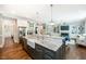 Open concept kitchen features a large island, granite countertops, and stainless steel appliances at 7101 Gibson Creek Pl, Cary, NC 27519