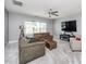 Bright living room featuring comfortable seating, a ceiling fan, and a large window at 7101 Gibson Creek Pl, Cary, NC 27519