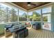 Inviting screened-in porch with outdoor seating, a fan, and views of the surrounding greenery at 7101 Gibson Creek Pl, Cary, NC 27519