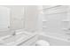 Pristine bathroom features white vanity, quartz countertop, and shower-tub combo at 764 Dorset Stream Dr, Fuquay Varina, NC 27526