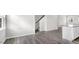 Open living area boasts stylish wood floors and a view of the modern kitchen with island at 764 Dorset Stream Dr, Fuquay Varina, NC 27526