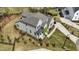 Aerial view of a beautifully landscaped home with a gray roof and a winding driveway at 8208 Bella Oak Ct, Wake Forest, NC 27587