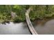 Aerial view of a vehicle crossing a bridge on a wooded lot at 8208 Bella Oak Ct, Wake Forest, NC 27587