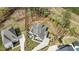 Expansive aerial view of stately house with mature landscaping, concrete driveway, and ample wooded acreage at 8208 Bella Oak Ct, Wake Forest, NC 27587