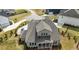 Aerial view of a home with a gray roof, green lawn, and a well-manicured landscape at 8208 Bella Oak Ct, Wake Forest, NC 27587