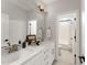 Bright bathroom features a double sink vanity with white countertop and well-lit mirror at 8208 Bella Oak Ct, Wake Forest, NC 27587