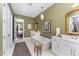 Spacious bathroom with standalone tub, dual vanities, and luxury light fixtures at 8208 Bella Oak Ct, Wake Forest, NC 27587