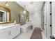Relaxing bathroom with soaking tub, double vanity, walk-in shower, and modern lighting at 8208 Bella Oak Ct, Wake Forest, NC 27587