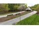 Scenic entrance to Hasentree with manicured lawns, flowering shrubs, and elegant signage, setting a refined tone at 8208 Bella Oak Ct, Wake Forest, NC 27587